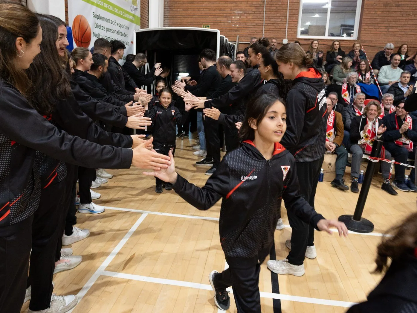 CB Grup Barna players walking onto the court to applause, 2025-2026 team presentation